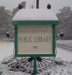 Library sign in the snow